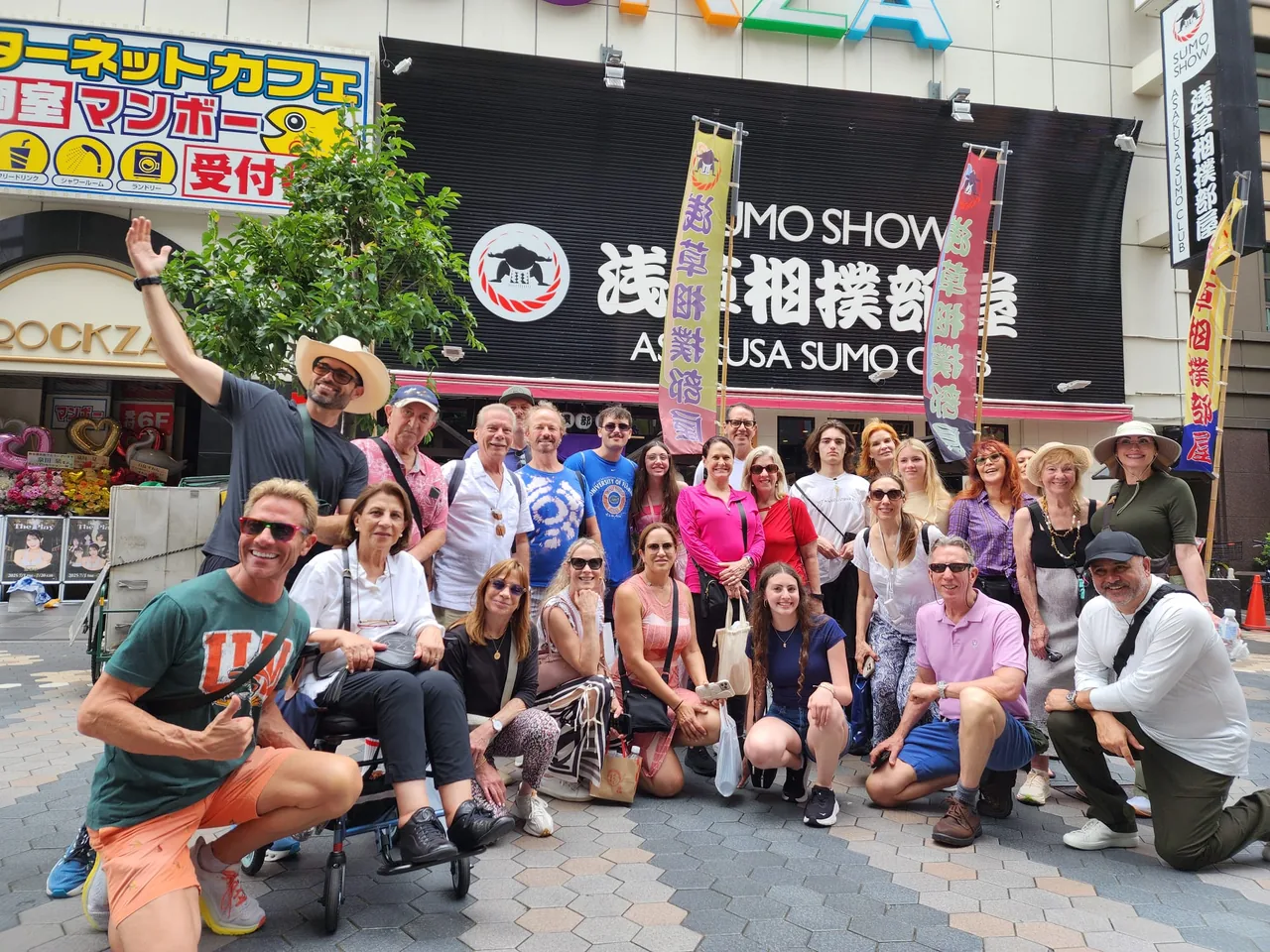 Tour guests outside a venue with sumo show signs